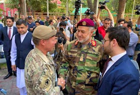 U.S. General Austin Miller, (left) shakes hand with Afghan Defense Minister Bismillah Khan Mohammadi on July 12, at a ceremony during the final phase of the withdrawal from the war in Afghanistan. Now Canada is scrambling to help Afghans who assisted its forces during the NATO-led effort. - REUTERS