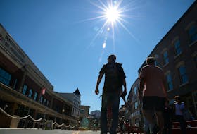 People visiting the pedestrian mall in downtown St. John's enjoy a sunny day as they take in the sights, sounds and smells of the outdoor eateries Monday, Aug. 9. Keith Gosse • The Telegram