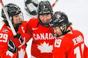 Marie-Philip Poulin, from left, Jocelyne Larocque and Brianne Jenner of Canada celebrate after teammate Jamie Rattray scored against United Sates during the IIHF Women’s World Championship gold-medal game at WinSport’s Markin MacPhail Centre in Calgary on Tuesday, Aug. 31, 2021.
