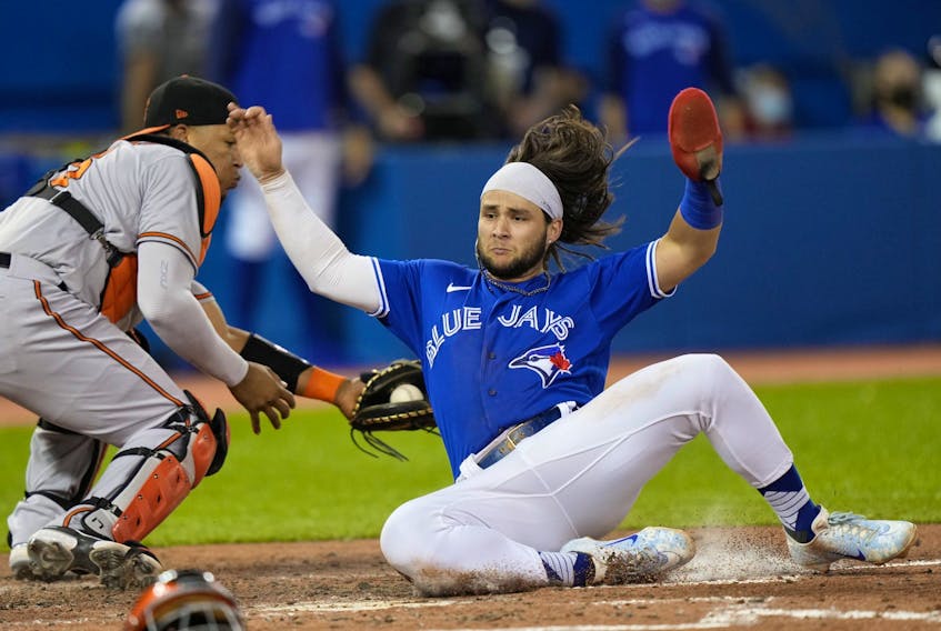 Toronto Blue Jays shortstop Bo Bichette scores as Baltimore Orioles catcher Pedro Severino misses the tag in the sixth inning at Rogers Centre in Toronto Blue Jays shortstop Bo Bichette scores as Baltimore Orioles catcher Pedro Severino misses the tag in the sixth inning at Rogers Centre in Toronto on Aug. 31, 2021.