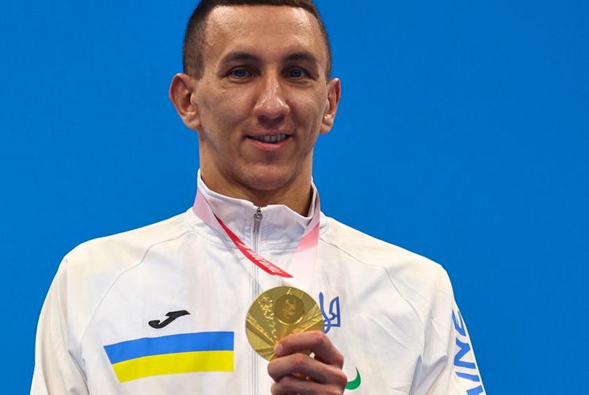 Tokyo 2020 Paralympic gold medalist Denys Dubrov of Ukraine celebrates on the podium, August 28, 2021. 