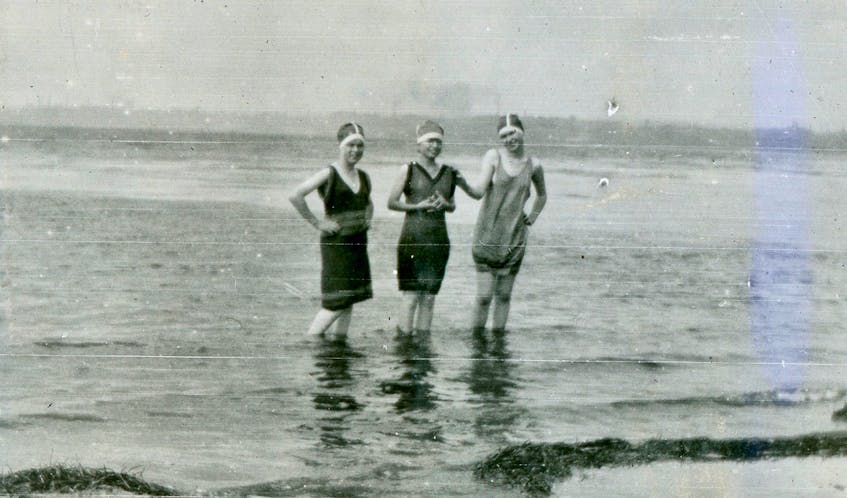 Three young women show off their 1930s-era swimsuits while wading in the water at Nelgah Beach. CONTRIBUTED • BEATON INSTITUTE DIGITAL ARCHIVES