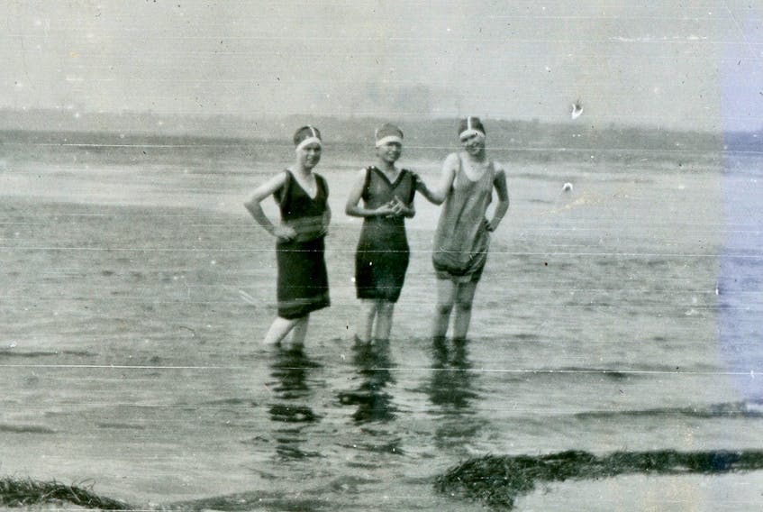 Three young women show off their 1930s-era swimsuits while wading in the water at Nelgah Beach. CONTRIBUTED • BEATON INSTITUTE DIGITAL ARCHIVES