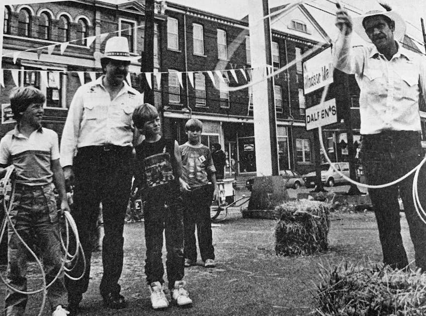 In August 1986, cowboy Gordon MacLeod, of Elmsdale, showed Darren Phillips and Andy Barker, standing with Jean Guy Picard who was the Maritime Rodeo Association promoter, the art of rope throwing. - File Photo