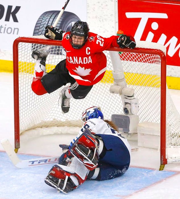 Team Canada’s Marie-Philip Poulin battles Team USA’s goalie Nicole Hensley in third-period action during the 2021 IIHF women’s world championship gold-medal game at the Winsport arena in Calgary on Tuesday, Aug. 31, 2021. - Darren Makowichuk / Postmedia
