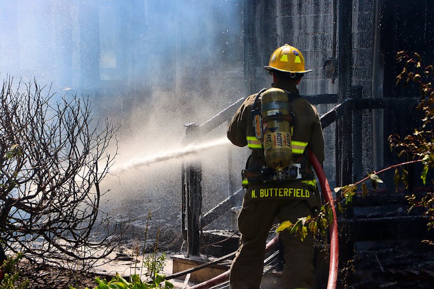 Kentville firefighter Nigel Butterfield worked to soak down hot spots. 
ADRIAN JOHNSTONE
 - Contributed