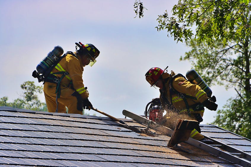 Waterville firefighter Fred Haggerty and Capt. Jeff Reid assisted with ventilation from the roof. This house on Lanzy Road sustained extensive damage Sept. 1.
ADRIAN JOHNSTONE
 - Contributed
