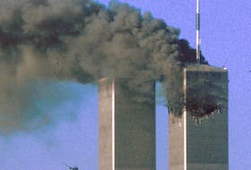 Hijacked United Airlines Flight 175 flies toward the World Trade Center twin towers shortly before slamming into the South Tower  as the North Tower burns, following an earlier attack by a hijacked airliner in New York, N.Y., on Sept. 11, 2001. REUTERS/Sean Adair/File Photo 