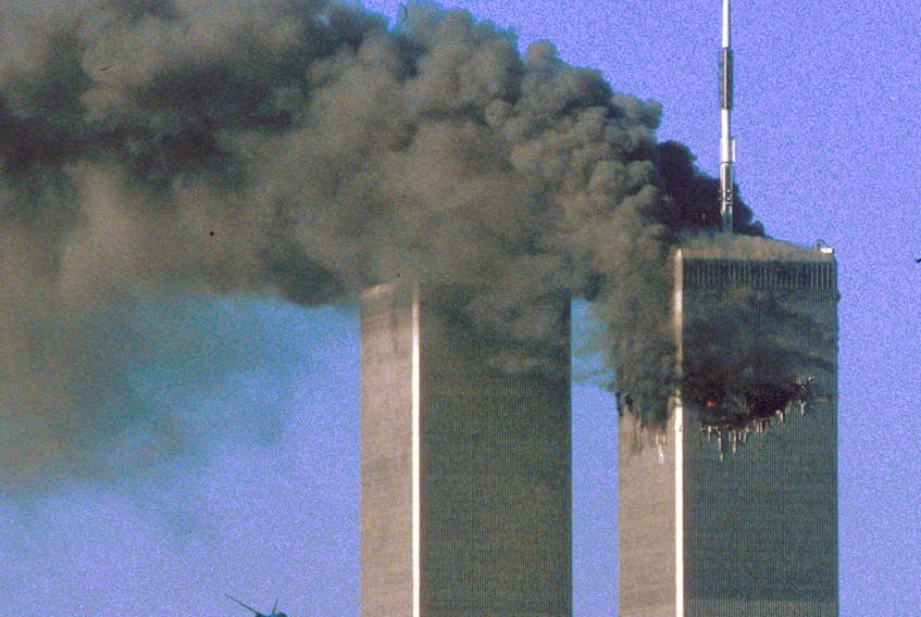 Hijacked United Airlines Flight 175 flies toward the World Trade Center twin towers shortly before slamming into the South Tower  as the North Tower burns, following an earlier attack by a hijacked airliner in New York, N.Y., on Sept. 11, 2001. REUTERS/Sean Adair/File Photo 