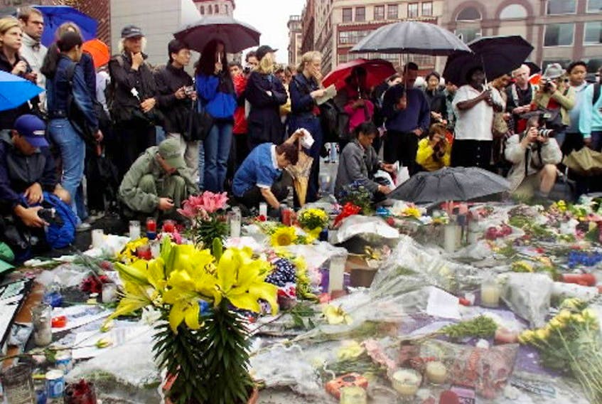 A group of people pay resprect at a memorial set up in Union Square in New York City on Friday, September 14/2001 which has been called a national day of mourning.