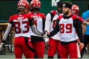  Calgary Stampeders Josh Huff (83) and Colton Hunchak (89) greet each other during warmup before a CFL game versus the Edmonton Elks at Commonwealth Stadium in Edmonton, on Saturday, Sept. 11, 2021. Photo by Ian Kucerak