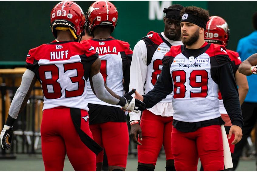  Calgary Stampeders Josh Huff (83) and Colton Hunchak (89) greet each other during warmup before a CFL game versus the Edmonton Elks at Commonwealth Stadium in Edmonton, on Saturday, Sept. 11, 2021. Photo by Ian Kucerak