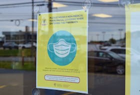 A mandatory mask notice in the window of the Medicine Shoppe Pharmacy on Welton Street in Sydney. Owner Hugh Toner says as of Wednesday the public will not have to wear a mask in his pharmacies but the staff will be wearing them. Sharon Montgomery-Dupe/Cape Breton Post