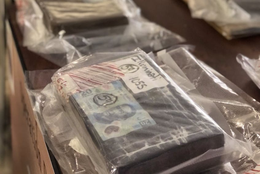 Close to half a million Canadian dollars, a shotgun, money counters and almost 11 kilograms of cocaine, some of it vacuum-sealed in bricks with Mexican pesos were seized as part of the RNC's Operation Rattle.