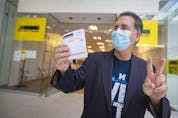  Windsor West candidate, Brian Masse, flashes his voting card after voting early at Devonshire Mall on Tuesday, Sept. 14, 2021.