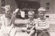  Snapshots from 1955, at Benny Farm in N.D.G.: Top, Andrew Caddell on skates for the first time outside the housing complex; and in the block yard, beside siblings Susan and Ian, left, with the family’s second-floor apartment behind them. Photo courtesy Caddell family.