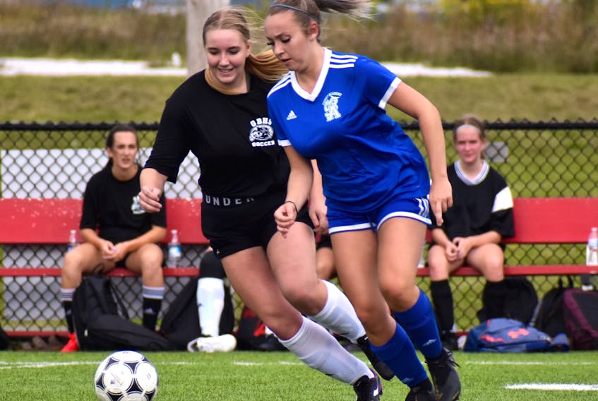 Ava Marks of the Sydney Academy Wildcats, right, works her way around Morgan O'Keefe of the Glace Bay Panthers during Cape Breton High School Soccer League girls' action at Open Hearth Park Turf in Sydney, Tuesday. The teams tied 1-1. JEREMY FRASER/CAPE BRETON POST