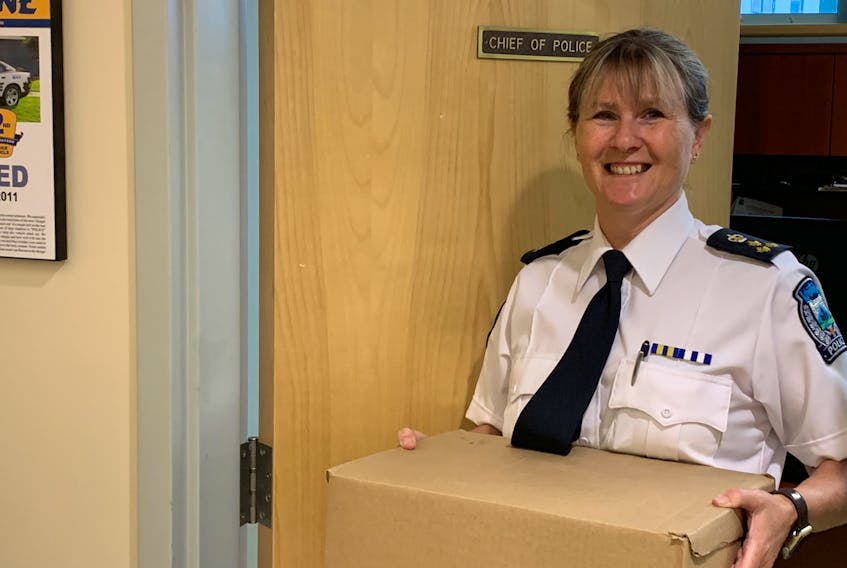 Kentville police chief Julia Cecchetto carries a box of belongings out of her office. Cecchetto,, the first female police chief in Nova Scotia, is retiring and counts increasing diversity on the force  as one of her accomplishments during her tenure.