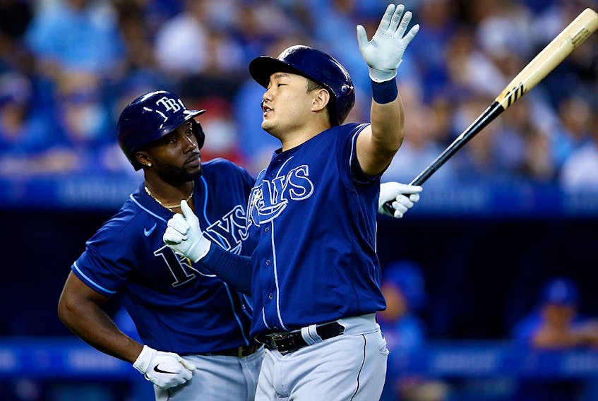 Ji-Man Choi of the Tampa Bay Rays celebrates with Randy Arozarena after hitting a solo home run against the Toronto Blue Jays at Rogers Centre on September 14, 2021 in Toronto.  