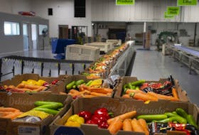 Fresh vegetables are packed into boxes and ready for shipment inside the newly unveiled Leamington Regional Food Hub, on Thursday, August 12, 2021.