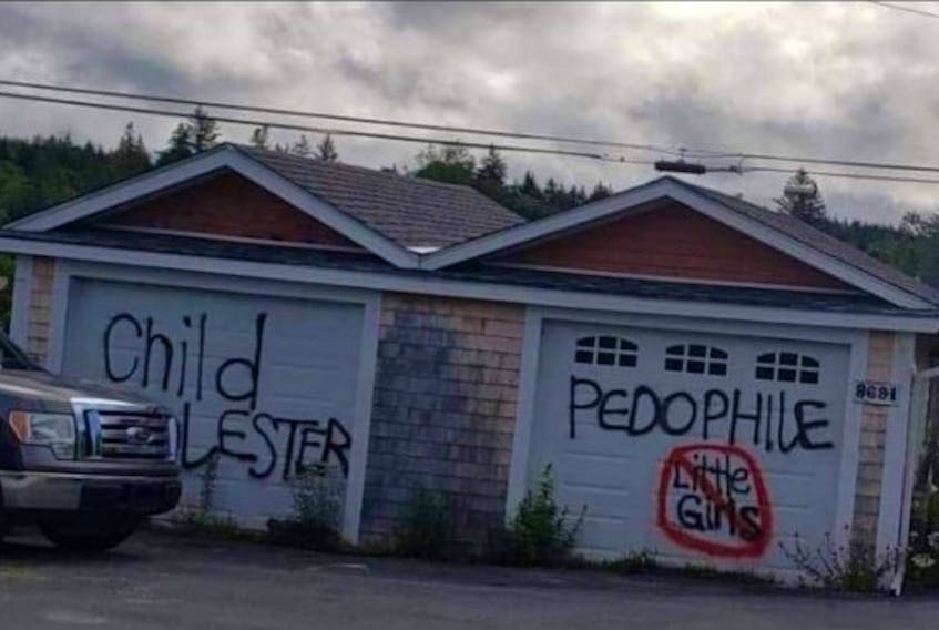 Michael Lynn Wentzell's garage in Voglers Cove was tagged with graffiti after he got parole on convictions for sexual assault and sexual exploitation.