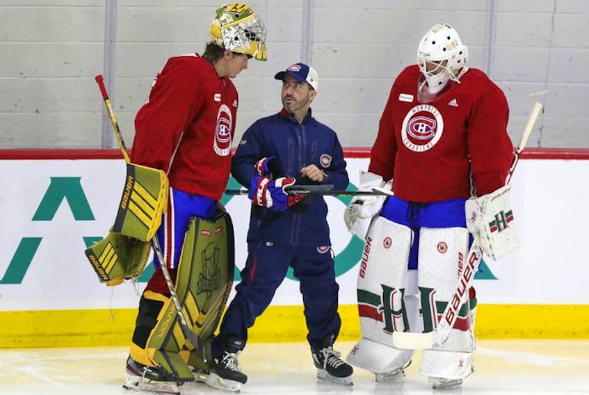 Laval Rocket goalie coach Marco Marciano looks up at 6'6" goalie Joe Vrbetic as Alexis Gravel listens on the first day of Montreal Canadiens' rookie camp at the Bell Sports Complex in Brossard on Thursday, September 16, 2021.
