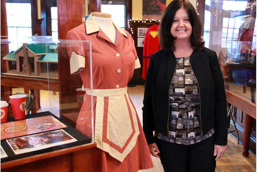  Irene Kerr, curator of the Highwood Museum, seen in 2015 with a display of Heartland memorabilia contained in the exhibit – On Location: Film in the Foothills. Fans of the TV show have helped keep the museum going with repeated visits.