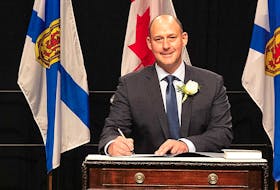 Dartmouth East MLA Tim Halman signs his oath of office after being sworn in as minister of environment and climate change in the Tim Houston-led Progressive Conservative government. -- Communications Nova Scotia