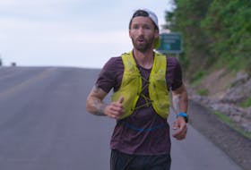An exhausted Jodi Isenor descends French Mountain as he worked his way around the entire 300-kilometre Cabot Trail in one go. CONTRIBUTED