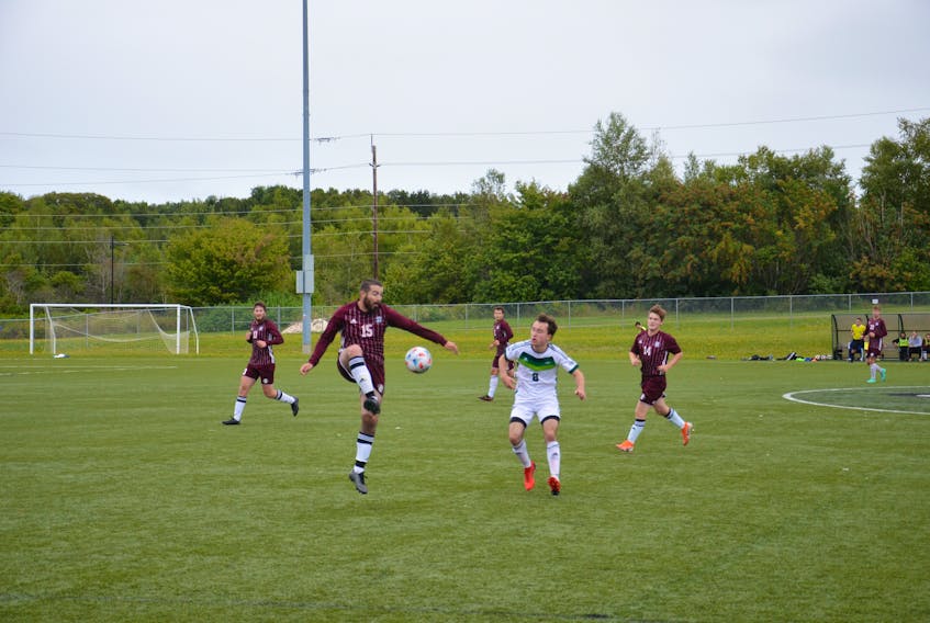 Dan Martell, 15, of the Holland Hurricanes plays the ball while under pressure from the UPEI Panthers’ Duncan Murray, 8, during an exhibition soccer game at UPEI recently. The Hurricanes host the University of King’s College Blue Devils in their Atlantic Collegiate Athletic Association (ACAA) home opener at the Terry Fox Sports Complex in Cornwall on Sept. 18 at 3:15 p.m.