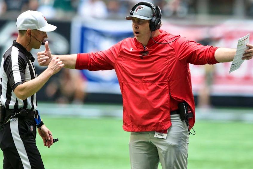 Atlanta Falcons head coach Arthur Smith talks with the referee against the Philadelphia Eagles during the first quarter at Mercedes-Benz Stadium. Officials have been specifically instructed this season to call offensive holding more or less on pre-2019 thresholds, league sources told Postmedia this week. USA TODAY