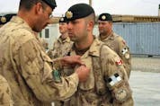 "It is still upsetting to think about, because you did have a connection there," Canadian veteran Matt Anderson (shown receiving pin) says of the collapse of Afghanistan's government to the Taliban.