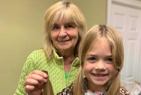 Barb Skinner with her granddaughter, Liviya Soulier, 7, who holds some locks of her hair after she had them cut to donate to Angel Hair for Kids, a charity that makes wigs for juvenile cancer patients. - Contributed