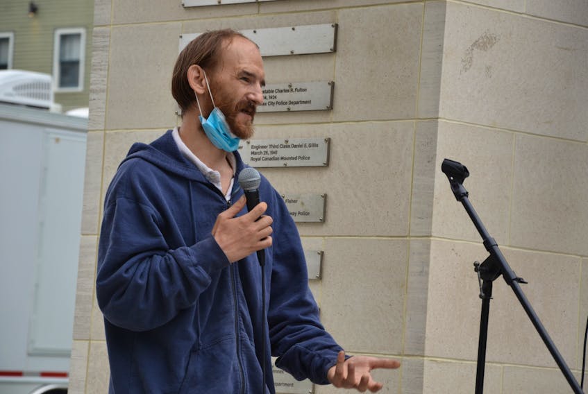 A man identified only as Malcolm speaks at a rally held Saturday at the Grand Parade in downtown Halifax to support a moratorium on the eviction of homeless people from tents and shelters in Halifax Regional Municipality.