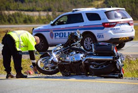 AN RNC officer marks the location of a motorcycle following a double-motorcycle crash on Peacekeepers Way Saturday afternoon. Keith Gosse/The Telegram