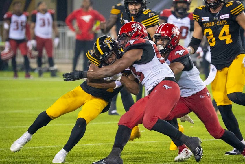  Hamilton Tiger-Cats receiver Papi White is stopped by the Calgary Stampeders’ defence at Tim Hortons Field in Hamilton, Ont. on Friday, Sept. 17, 2021.