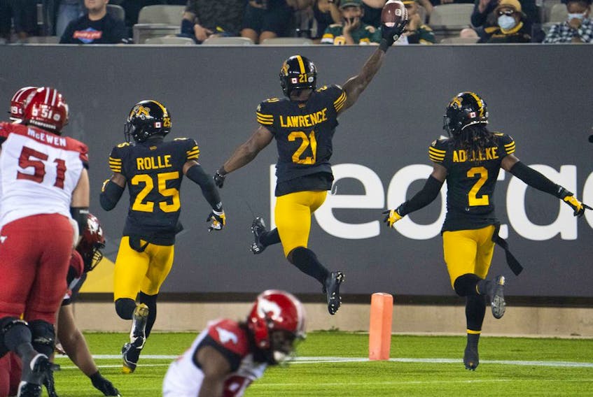 Hamilton Tiger-Cats linebacker Simoni Lawrence (21) celebrates his touchdown against the Calgary Stampeders at Tim Hortons Field in Hamilton, Ont. on Friday, Sept. 17, 2021.