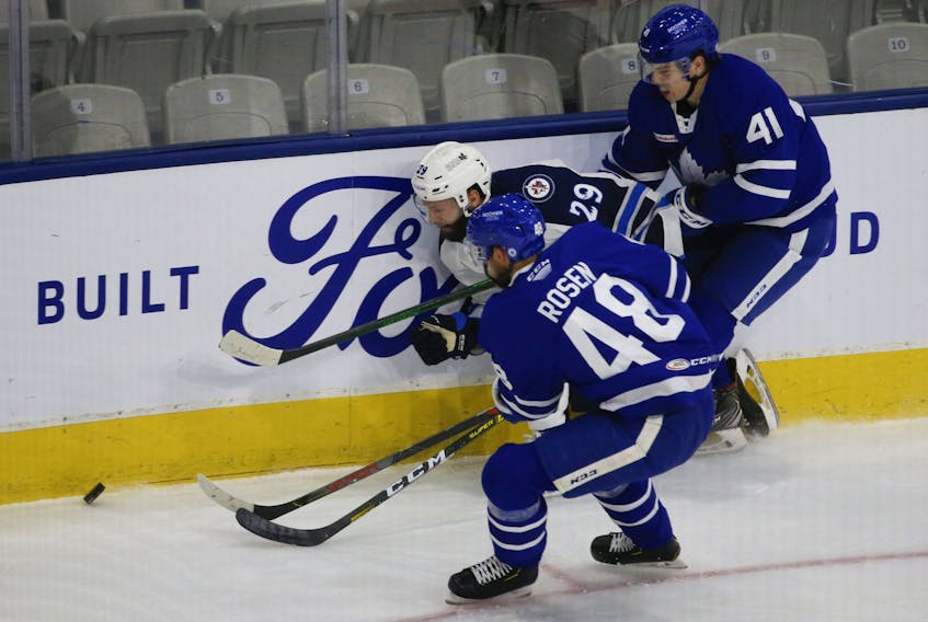 Leafs prospect Jeremy McKenna (41), here working the boards for he Marlies, scored twice in a rookie tourney win over the Blues yesterday in Michigan. 