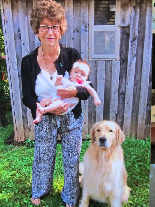 Cindy Weatherbie holds her special granddaughter Isla while her dog-friend Norman stays close. - Contributed