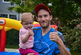 Eddie Fowlow and his daughter, Lexi, pose for a photo in the backyard of their Coley’s Point home on Thursday afternoon. A call for donations recently has helped Eddie get a new car to help his family.