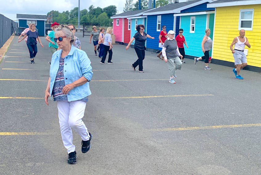 Linda Campbell, front, leads the Sydney Stompers line dancing group through a practice on the Sydney waterfront Thursday morning. Campbell, who is from Dominion, has been teaching for 30 years. She said anyone interested in learning to line dance can email her at lindadance2020@gmail.com. Chris Connors • Cape Breton Post