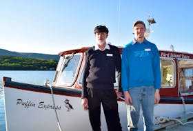 Capt. Vince Van Schaick, left, co-owner of Bird Island Boat Tours in Big Bras d'Or, and his son Capt. Ian Van Schaick, in front of their boat called the Puffin Express, in roughly 2018. Picture courtesy of Bird Island Boat Tours