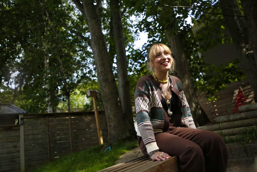 Grade 11 student Rae Stevens sits in the backyard of her family's home in Halifax on Wednesday, Sept. 1, 2021.
