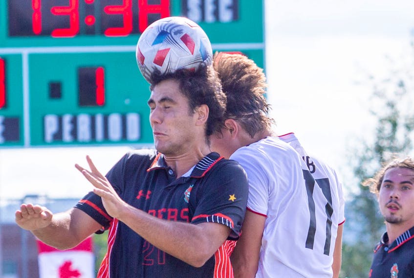 Cape Breton's Jose Maria Ribeiro de Cunha, left, and New Brunswick's Luke Rosettani challenge for the ball during Atlantic University Sport men's soccer action at Willie O’Ree Place Complex in Fredericton on Saturday. New Brunswick won the game 4-2. PHOTO CONTRIBUTED/JAMES WEST, UNB ATHLETICS