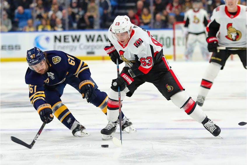 Sabres winger Michael Frolik attempts to block a pass by the Senators' Tyler Ennis during the first period of play on Tuesday, Jan. 28. 2020.