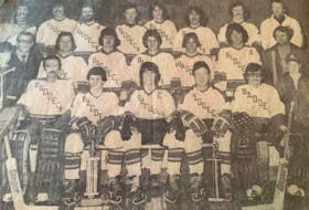 The Baddeck Gillis' Cats captured the Cape Breton Intermediate 'D' Hockey League championship, before losing in the provincial playdowns. The year for the title was not available. Front row, from left, Peter Woodford (stick boy), Roddie MacDonald, Patti Woodford, Jamie Campbell, Fraser MacLeod, Murdock MacLean, and Michael Harvey (stick boy). Middle row, from left, Murdock Matheson (manager), Sandy Gregg, Duncan MacKenzie, Shaun Dunlop, Fred MacLeod, Donald MacKenzie, and Duncan Gillis (sponsor). Back row, from left, Dr. Eollie Genge (team physician), Ernie MacIntosh, Tim Burkhart, Dave MacRae, Frankie MacDonald, Malcie MacIntyre, David Fraser, and Mickey Woodford (coach). PHOTO CONTRIBUTED.
