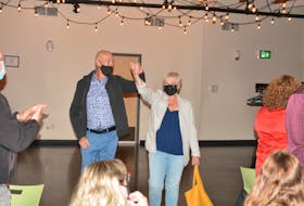 Liberal candidate Ken McDonald (left) for the district of Avalon raises his arms in victory alongside his wife Trudy moments after he was declared victorious in the 2021 federal election.