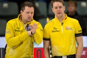 Third stone Adam Casey, right, chats with skip Jason Gunnlaugson during the 2021 Tim Hortons Brier Canadian men’s curling championship in Calgary, Alta. 