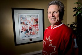 Canadian  hockey hero Paul Henderson  stands beside a painting of his famous goal to beat Team Russia in 1972. Postmedia