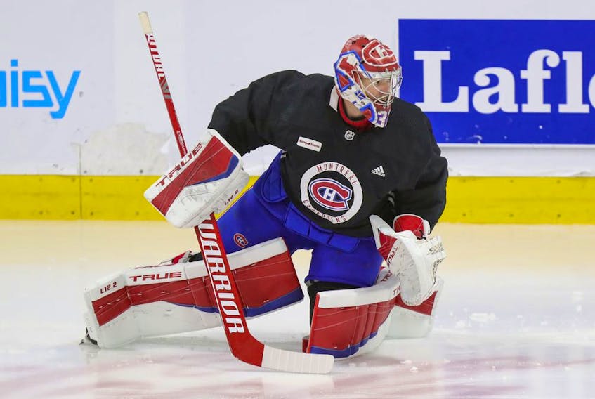 Montreal Canadiens' Carey Price does some exercises on the ice under the supervision of a member of the team's training staff at the Bell Sports Complex in Brossard on Sept. 16, 2021.  Price had off-season knee surgery.  